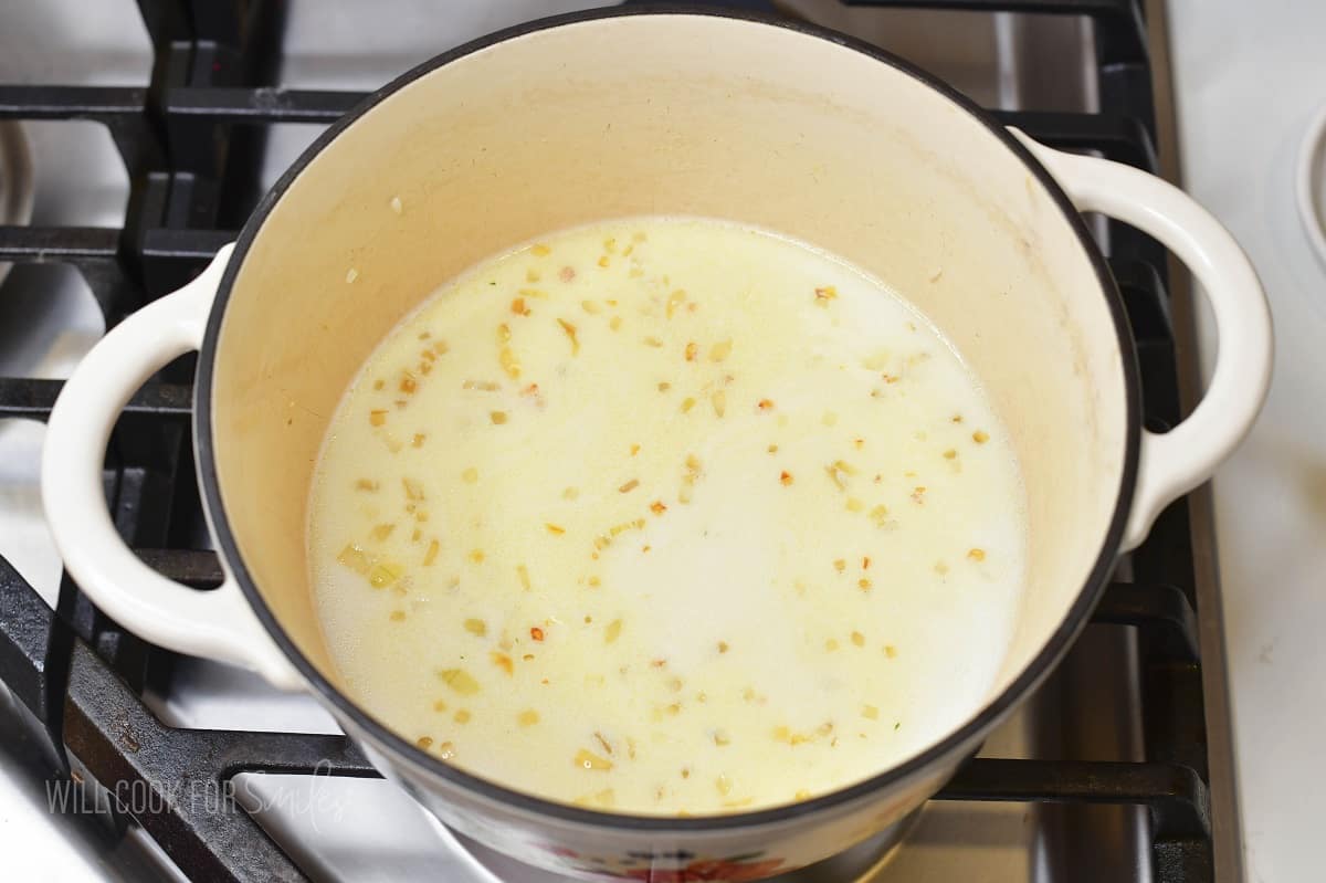 rice in creamy broth in a pot before cooking.