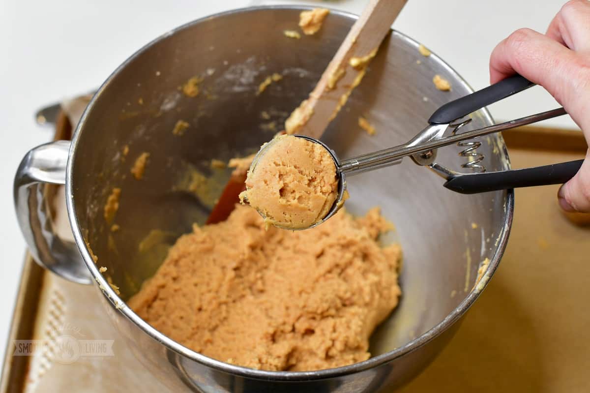 scooping out some cookie dough with cookie scoop.