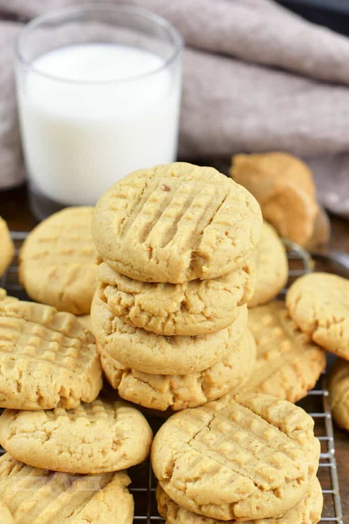 stacked several peanut butter cookies and milk.