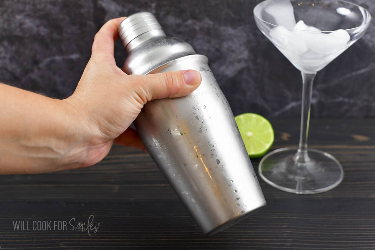 shacking the martini in a cocktail shaker.