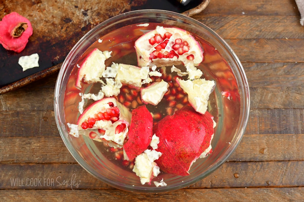 separating pomegranate seeds in water.