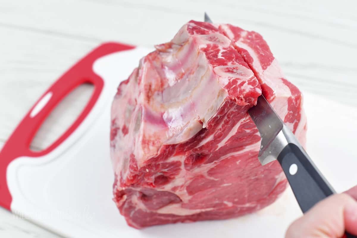 slicing off the rib bone off the prime rib.