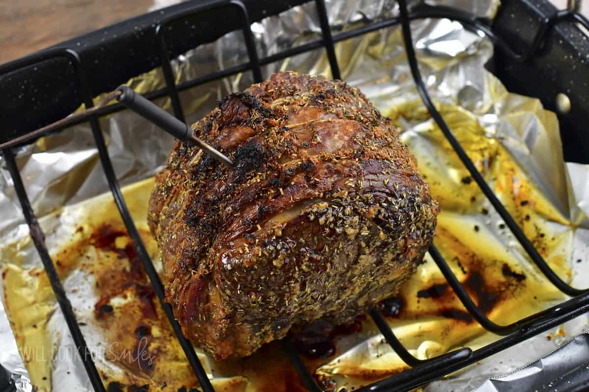 cooked prime rib roast in the roasting pan.