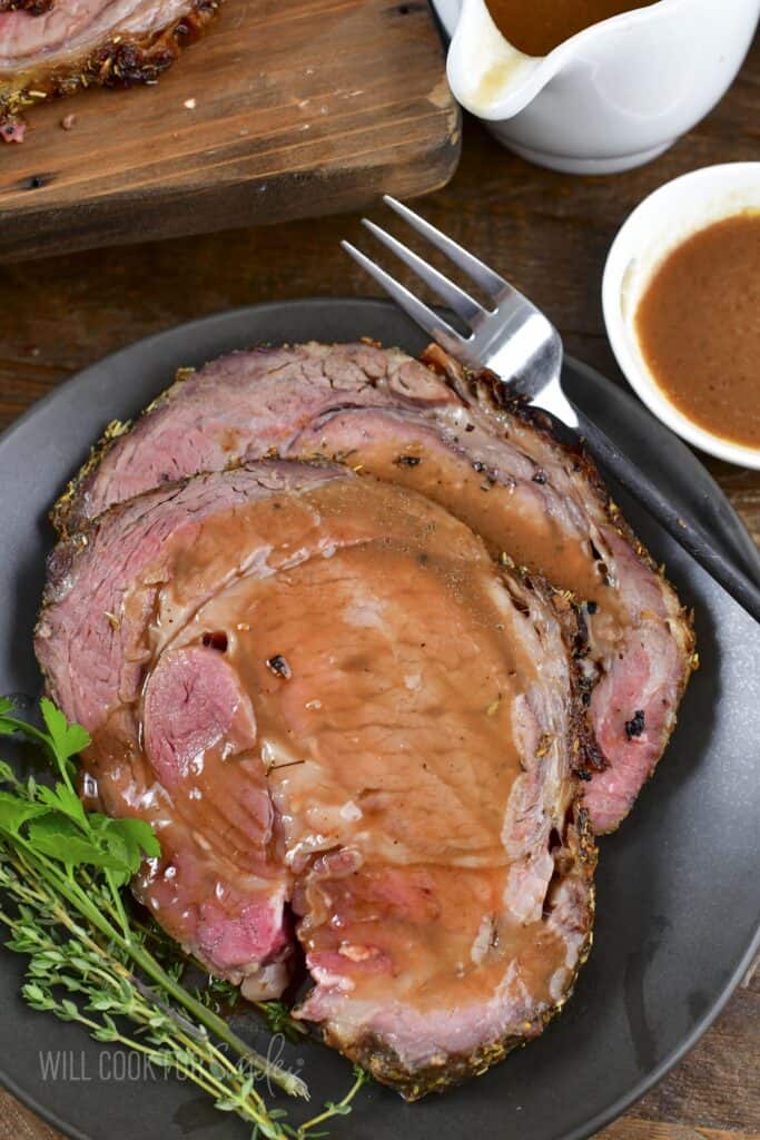 top view of two slices of prime rib topped with au jus.