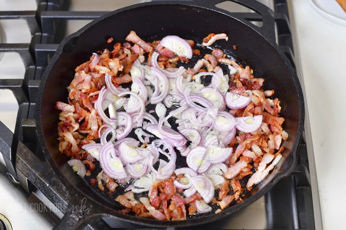 sautéing onions and bacon in a skillet.