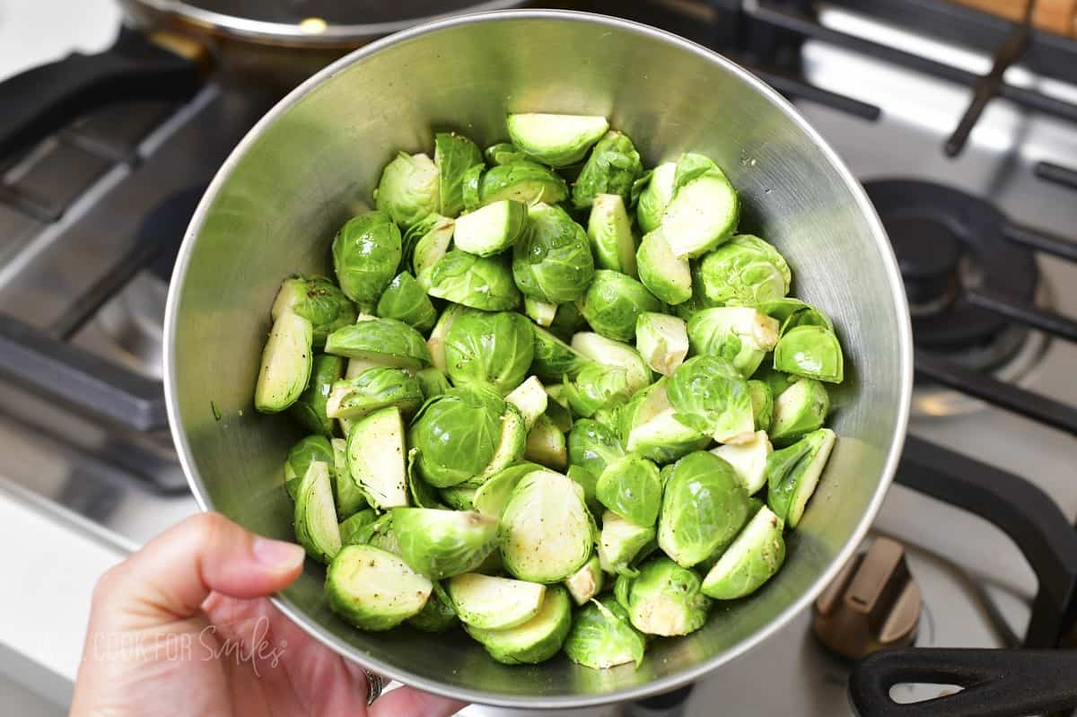 cut brussels in a bowl seasoned with salt and pepper.