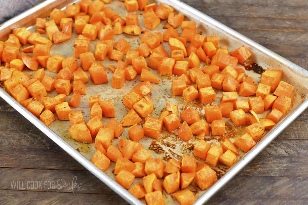 roasted cubed sweet potatoes on a baking sheet.