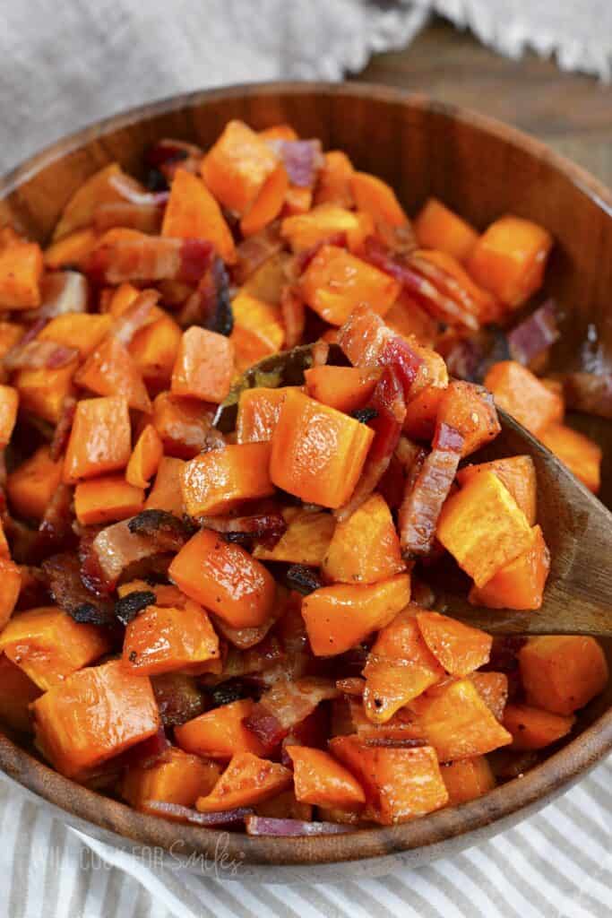 scooping out some roasted potatoes and bacon.