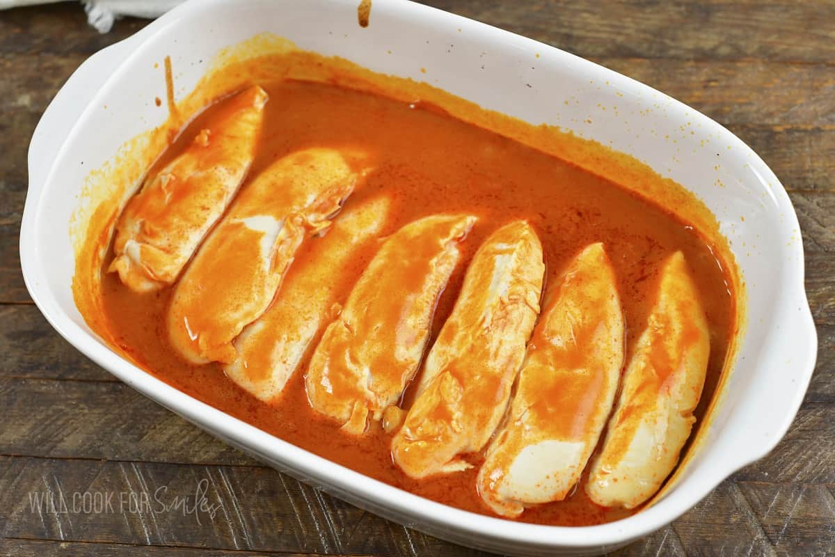 baked chicken tenders in winger sauce in a baking dish.
