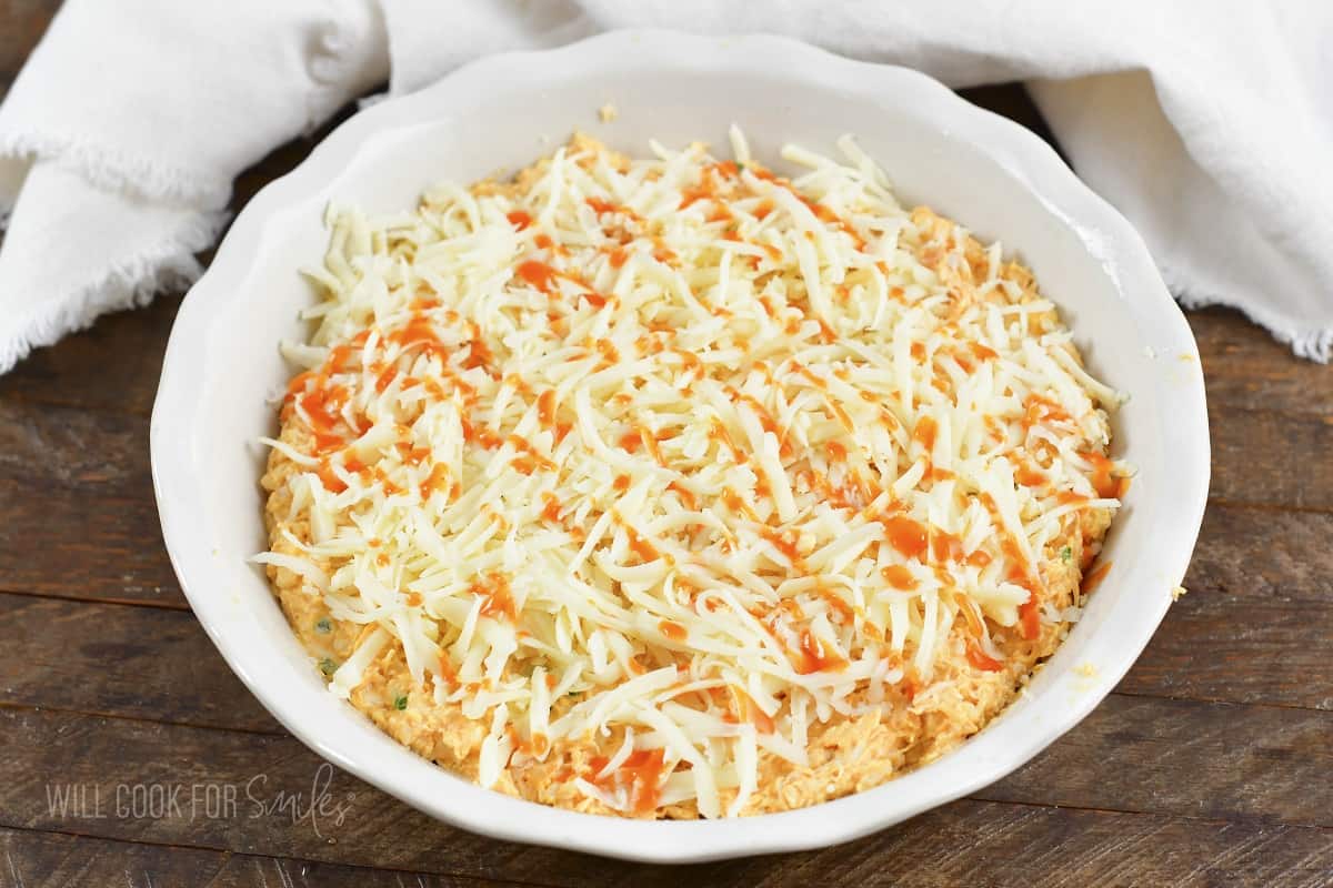 shredded cheese and drizzle of winger sauce over buffalo dip.