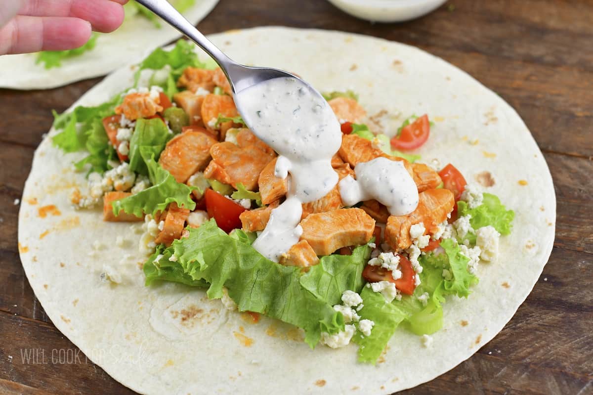 adding homemade ranch dressing to the wrap filling.