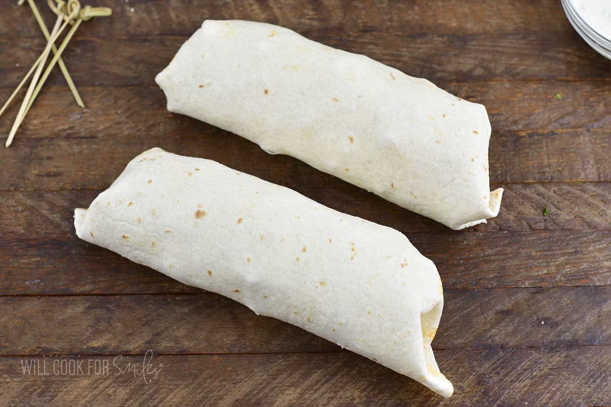 two rolls wrapped on the wooden board.