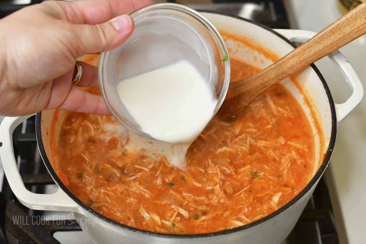adding heavy whipping cream to the soup.