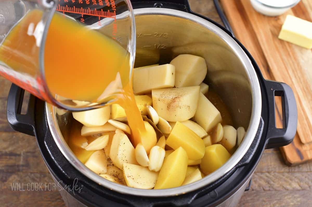 adding broth to the cubed potatoes in instant pot.