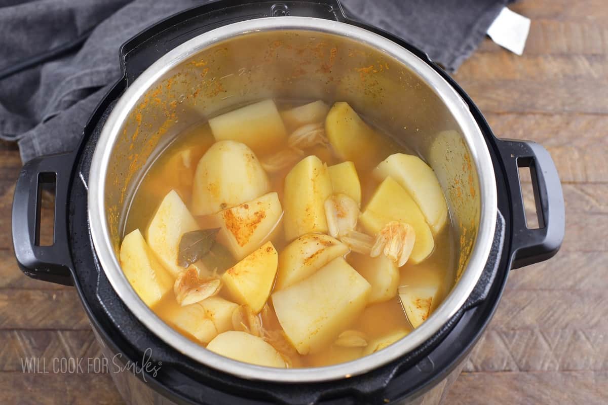 cooked potatoes in broth in a pot of instant pot.
