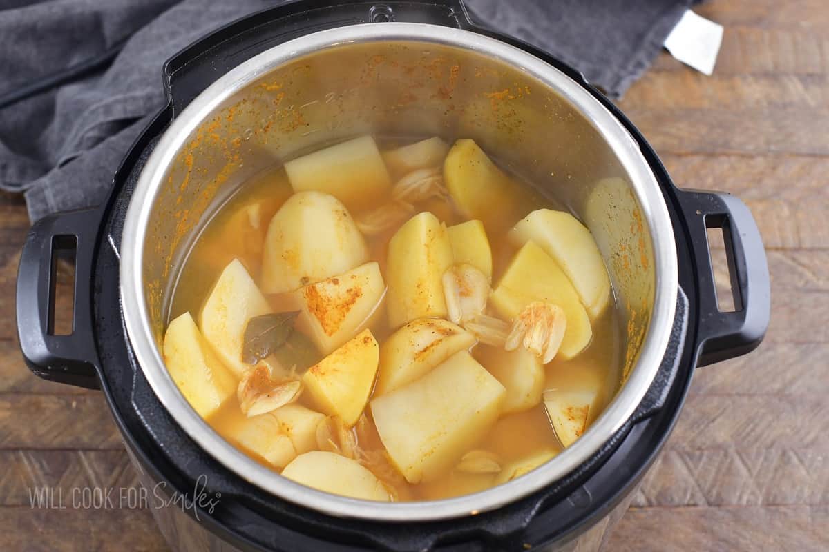 cooked potatoes in broth in a pot of instant pot.