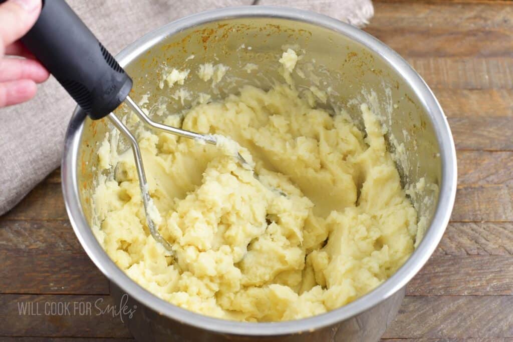 mashed cooped potatoes in a silver bowl.