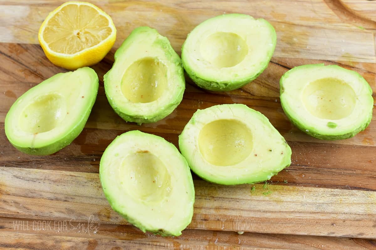 peeled avocado halves on the cutting board.