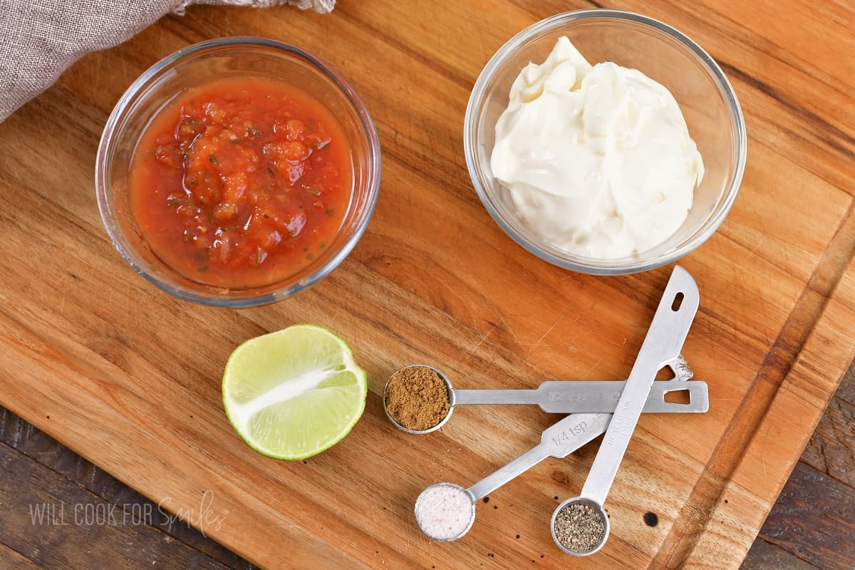 ingredients for creamy salsa dressing on cutting board.