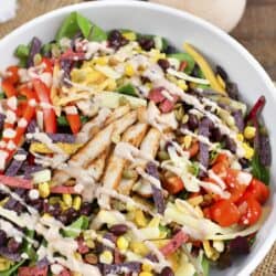 top view of southwest salad in a bowl drizzled with dressing.