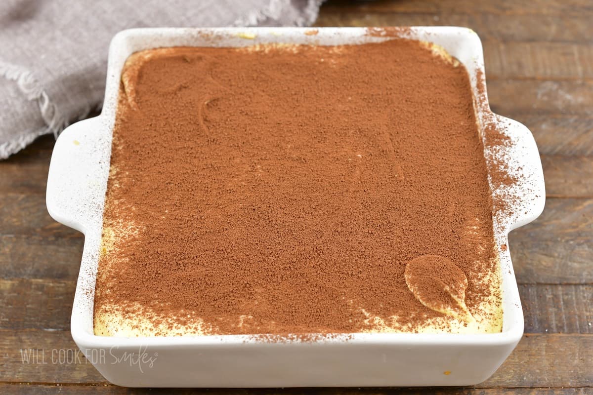 tiramisu finished in a white baking dish.