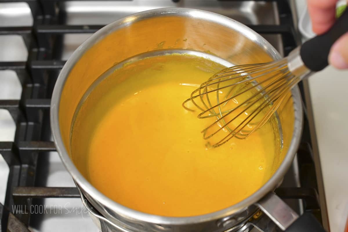 stirring egg yolks in a double boiler.