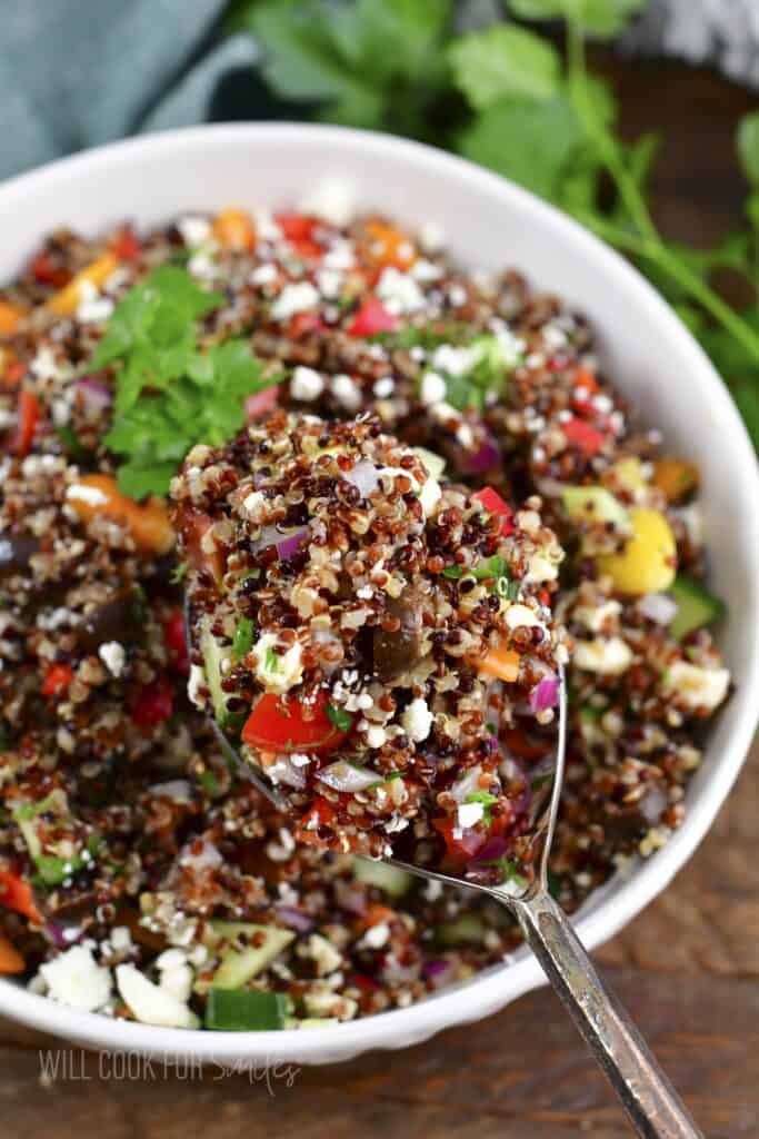 closeup of spoonful of Mediterranean quinoa salad.