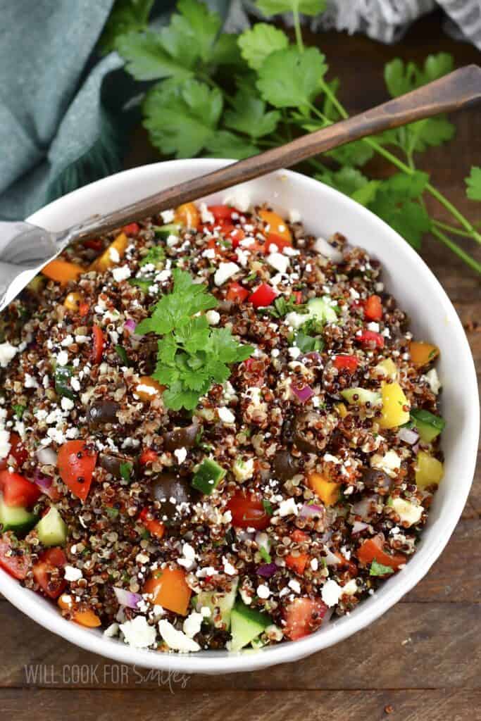 top view of colorful quinoa salad in a white bowl.