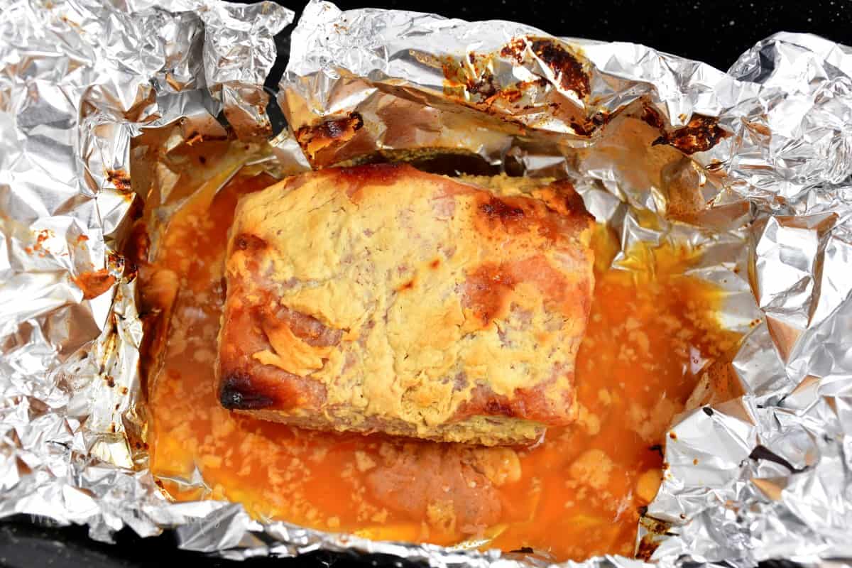 cooked corned beef brisket on aluminum foil.
