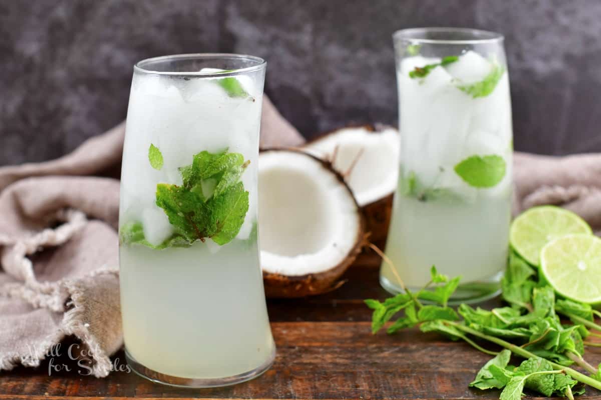 two white coconut mojito cocktails with coconuts.