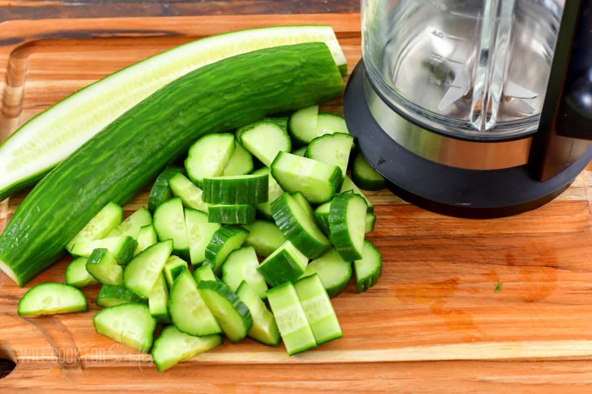 chopped cucumbers next to the blender.
