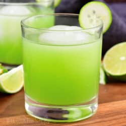 closeup centered bright green cocktail with ice in glass
