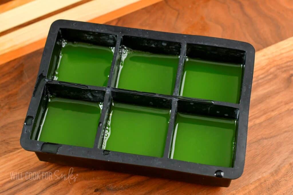 cucumber juice in the black ice cube mold.