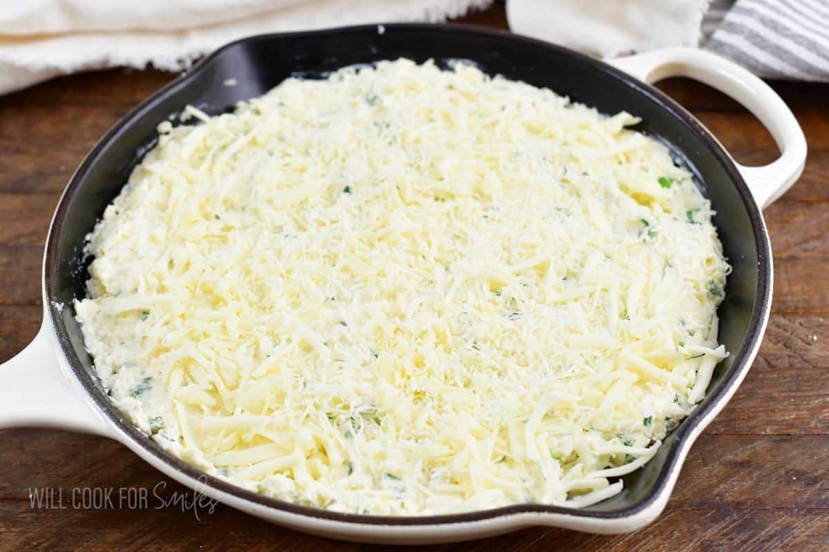 four cheese dip in a skillet before baking.