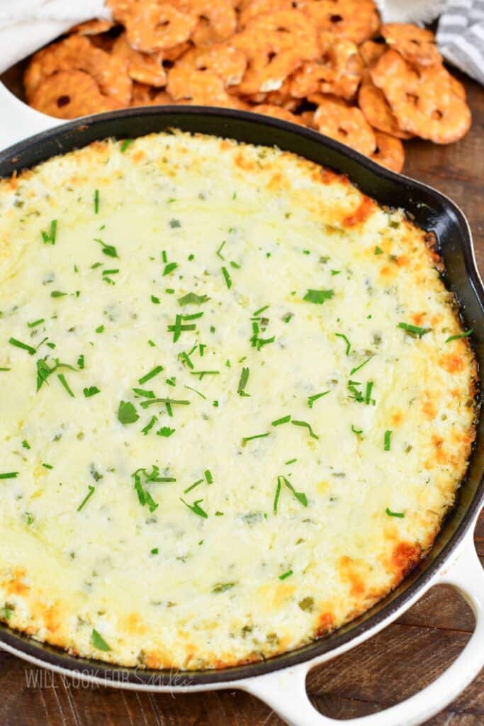 top view of baked four cheese dip and pretzels.