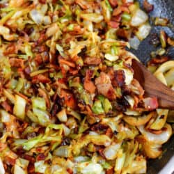 closeup of scooping of fried cabbage and bacon.