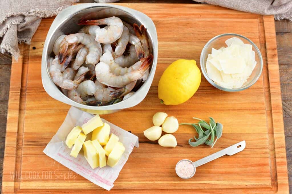 ingredients for garlic butter shrimp on wooden board.