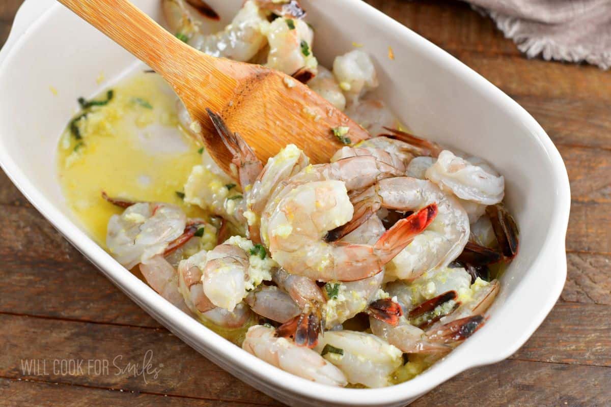 mixing shrimp with melted butter mixture.