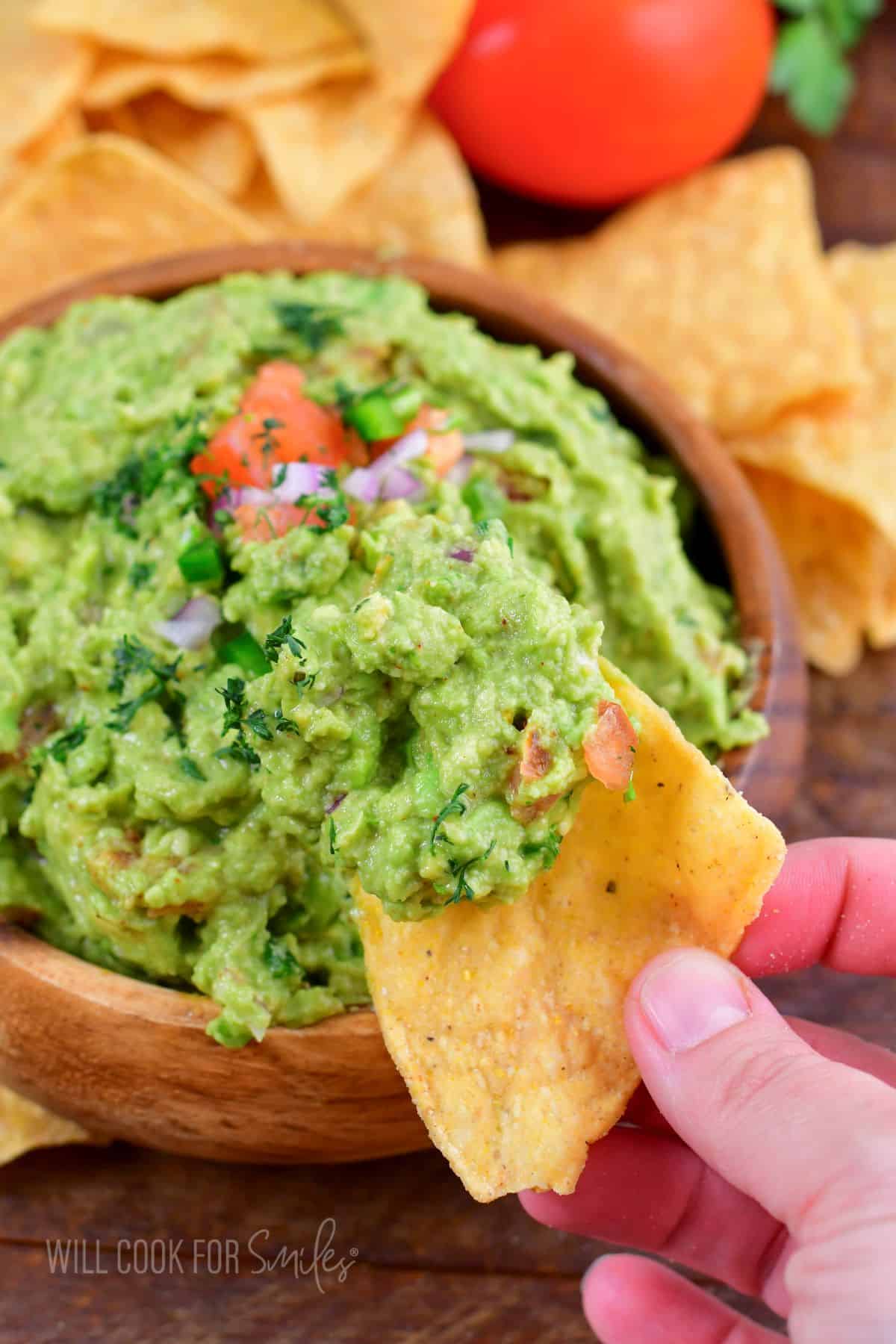 some guacamole on a yellow tortilla chip.
