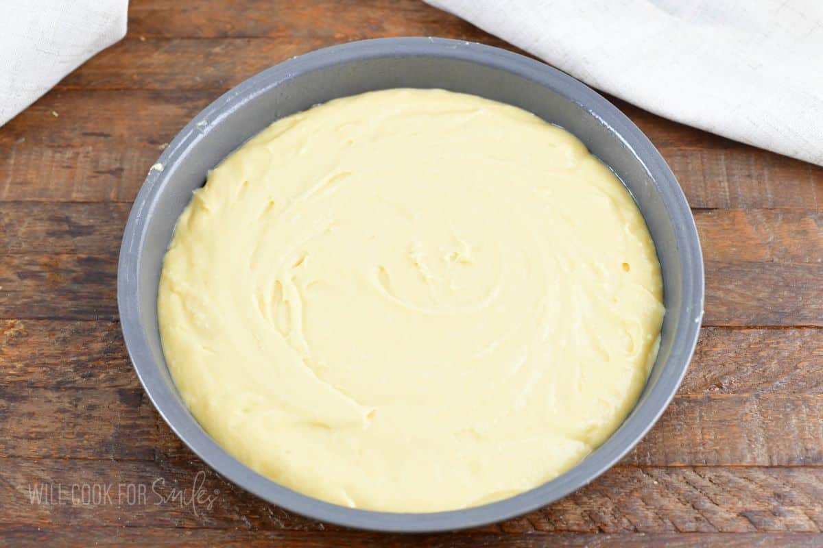 cake batter spread in the round cake pan.