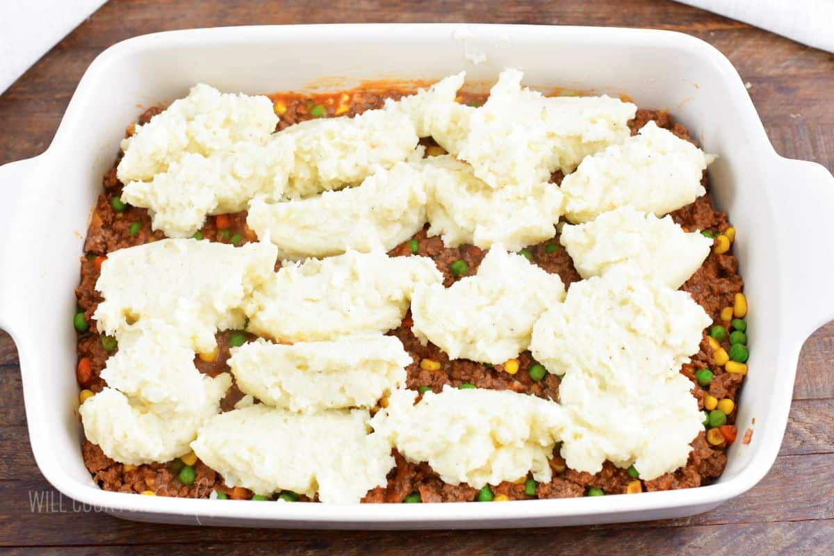 scoops of mashed potatoes all over the beef layer.