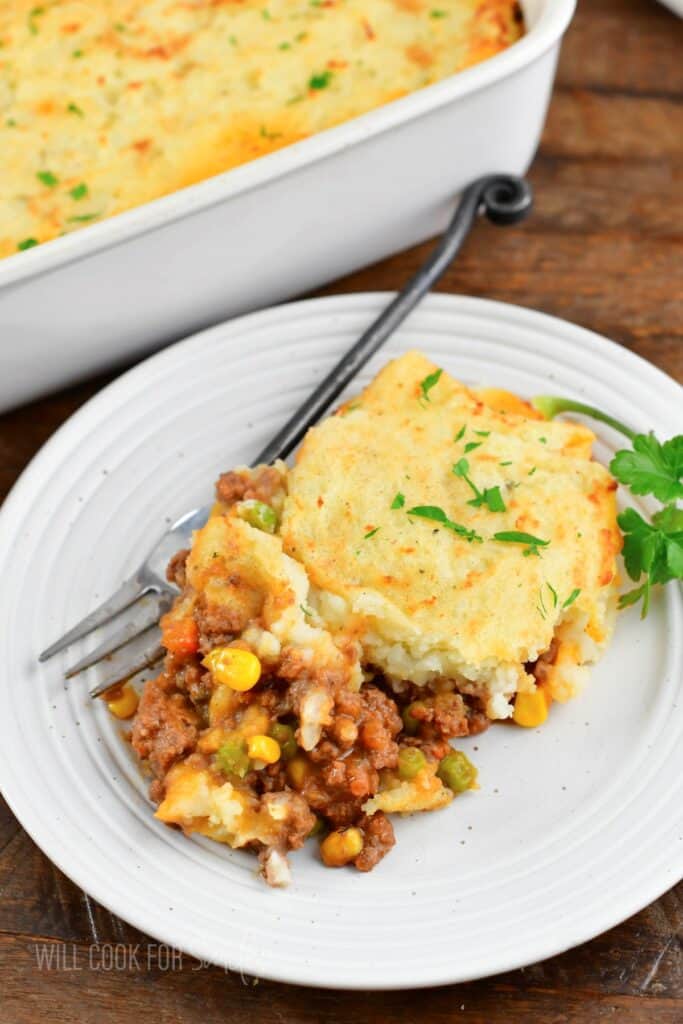 some shepherd's pie in a dish with a fork.