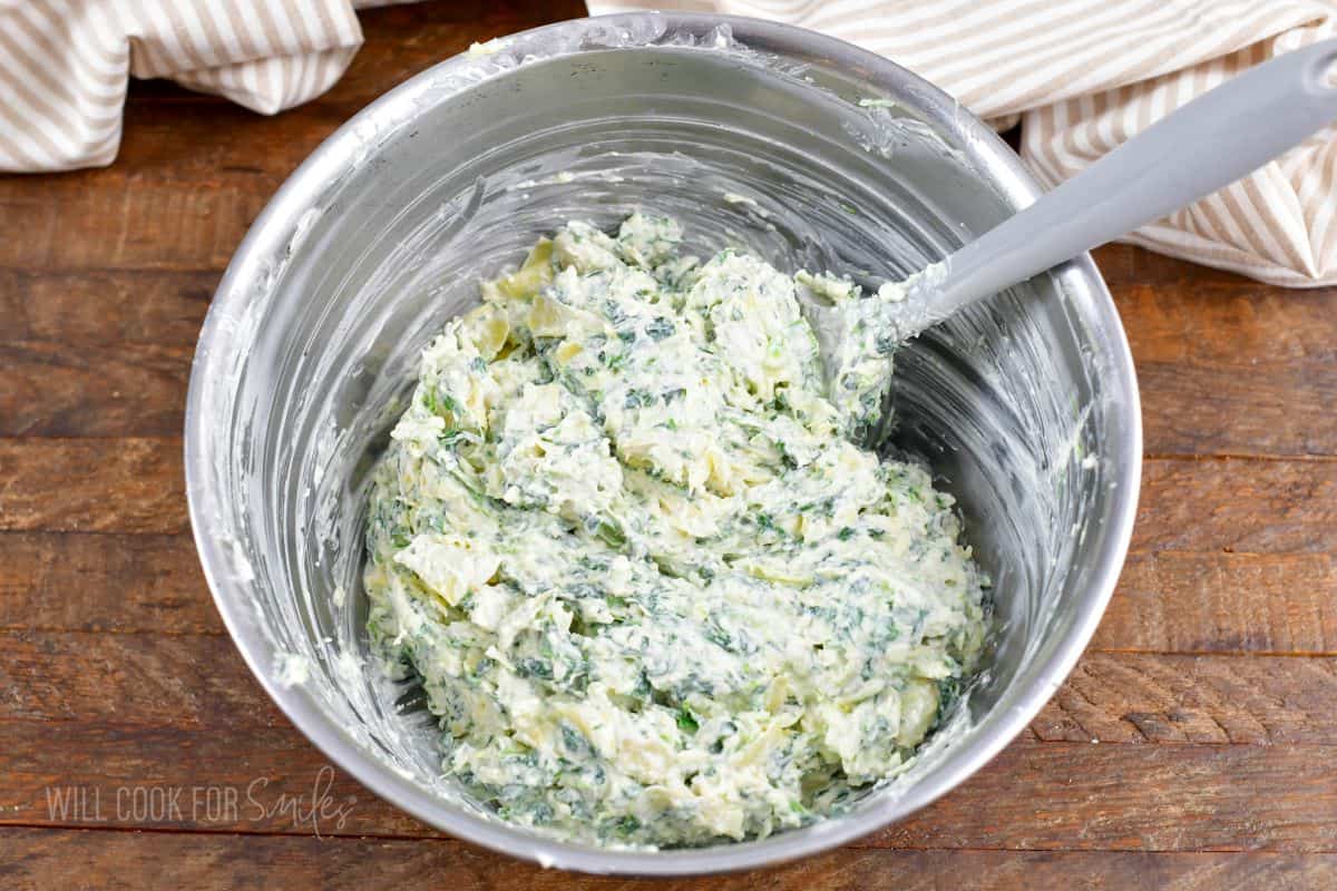 mixed spinach dip ingredients in a mixing bowl.