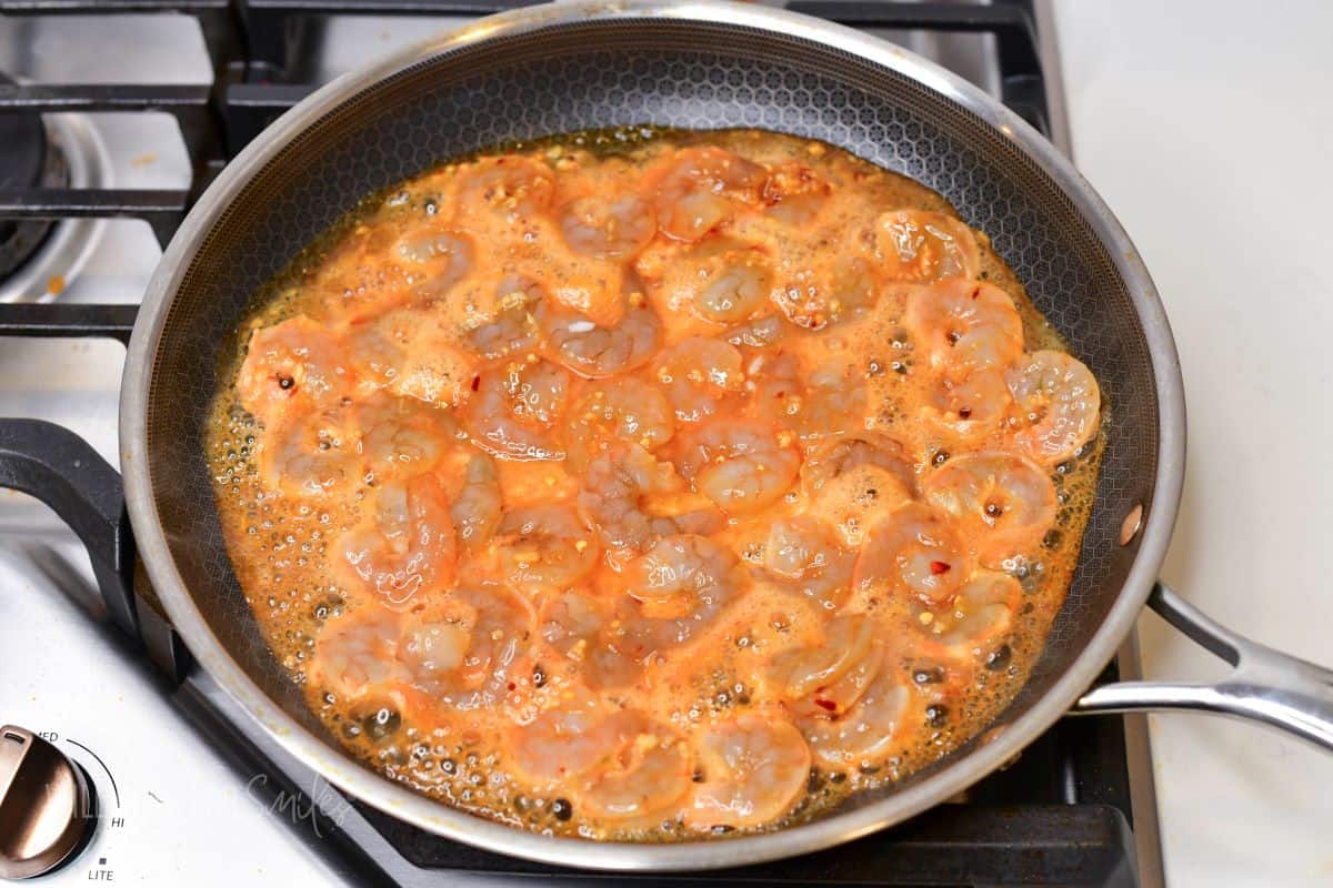 shrimp cooking in Thai style sauce in a pan.