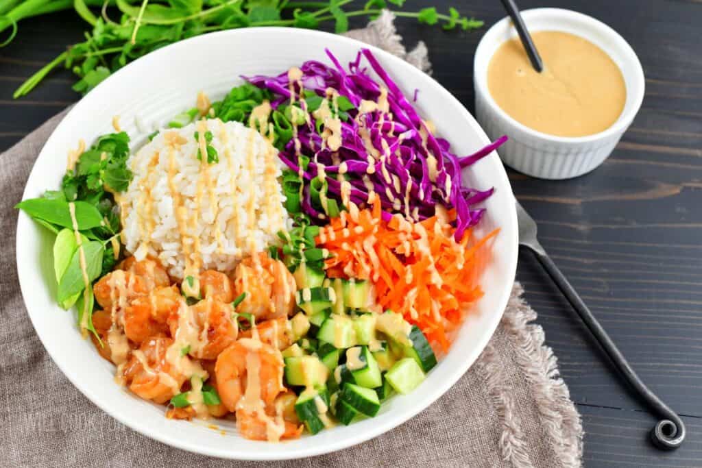top view of spring roll bowl drizzles with peanut sauce.