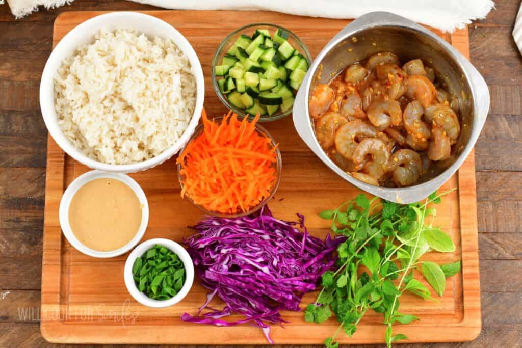 ingredients for a spring roll bowl on cutting board.