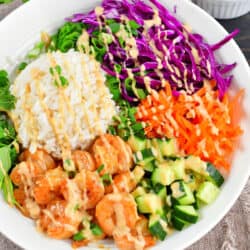 closeup of the top view of spring roll bowl drizzled with peanut dressing.