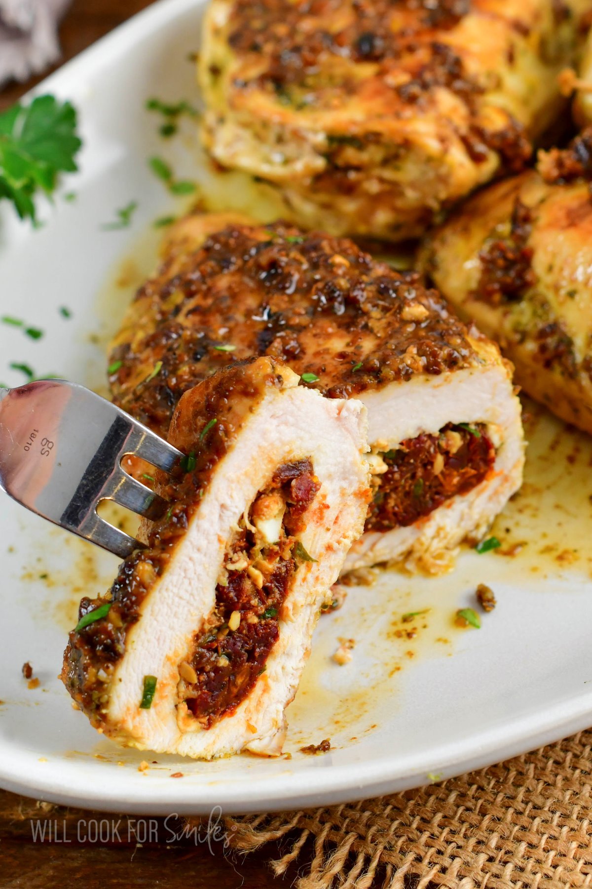 cutting into a stuffed chicken breast and view inside.