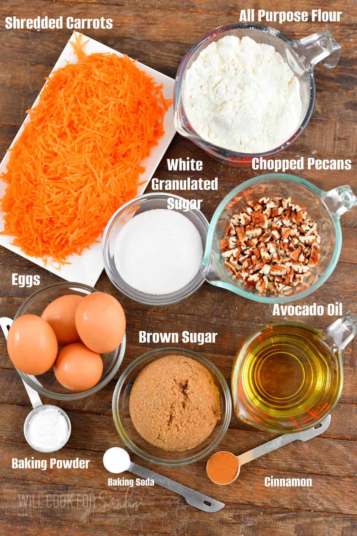 labeled ingredients for the carrot cake on the wooden board.