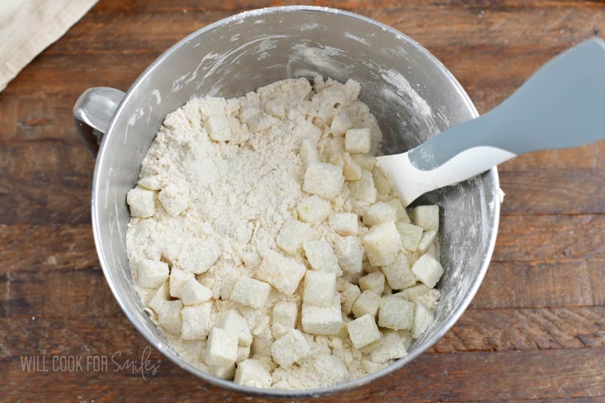 mixing apple chunks into the flour mixture.